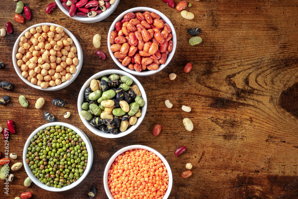 Legumes, top shot on a dark rustic wooden background Legumes, top shot on a dark rustic wooden background