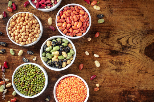 Legumes, top shot on a dark rustic wooden background