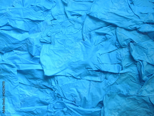 Pile of blue color disposable medical gloves