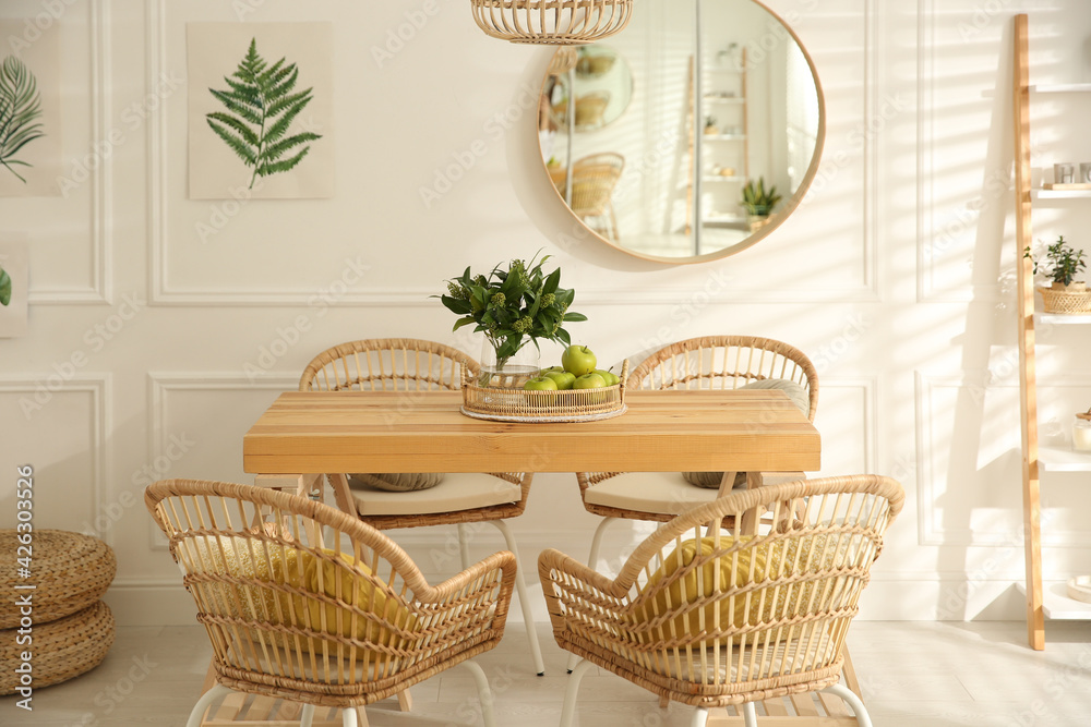 Fototapeta premium Stylish wooden dining table and chairs in room. Interior design