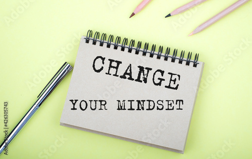 Wallpaper Mural Change Your Mindset text on the notebook with pen on yellow background Torontodigital.ca