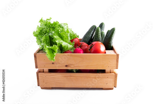 Wooden crate full of fresh vegetables from the garden