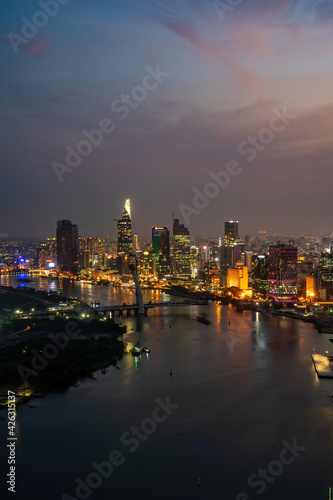 Aerial view of Ho Chi Minh city, Vietnam. Beauty skyscrapers along river light smooth down urban development. Dramatic lighting spectacular night.