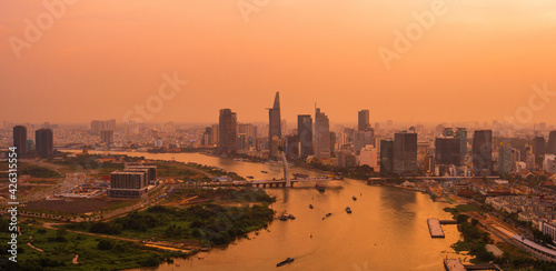 Aerial view of Ho Chi Minh city, Vietnam. Beauty skyscrapers along river light smooth down urban development. Dramatic lighting spectacular sunset. photo