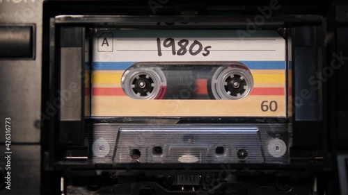 4K: Audio Cassette 1980s Tape playing in Recorder - Vintage Eighties or 80s retro music. Stock Video Clip Footage