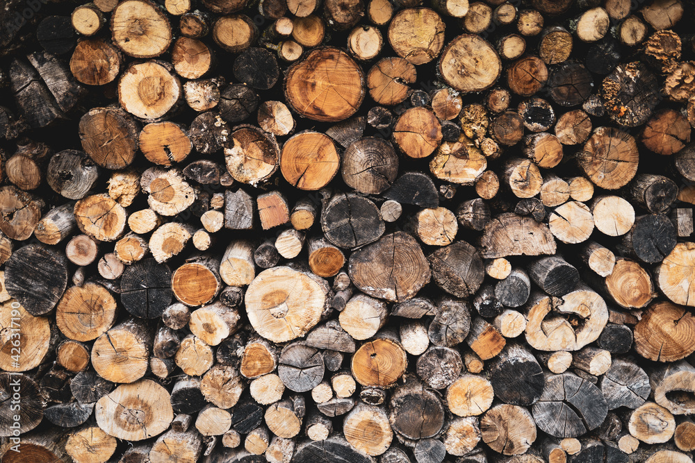 Stacked logs of wood, wooden background, firewood, brown. Wallpaper Texture, graphic resources. Stacked logs of wood, wooden background, firewood, brown. Wallpaper Texture, graphic resources.