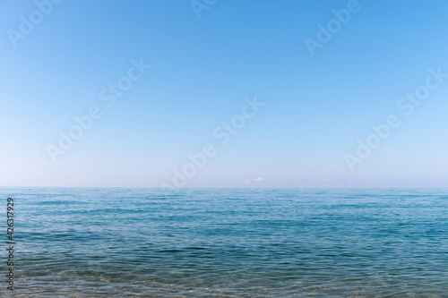 Calm morning sea. Small waves in calm conditions. Sea background