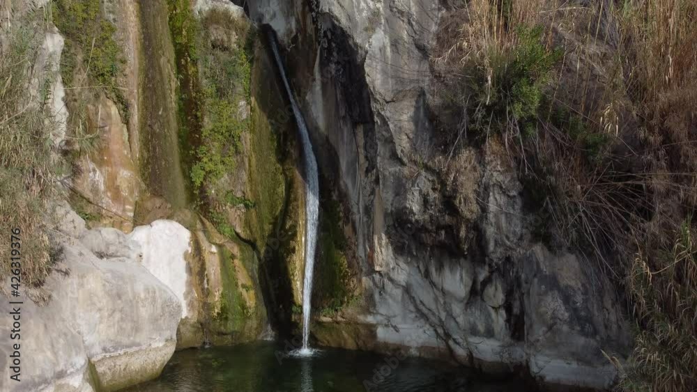 Travelling up moving from a view of a waterfall and its pool in dry season to the top of the mountain Travelling up moving from a view of a waterfall and its pool in dry season to the top of the mountain