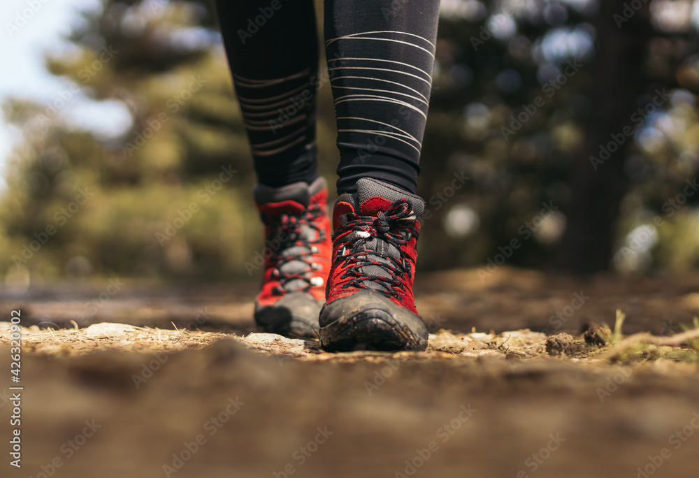 Close- up of hiking boots walking in the mountain Close- up of hiking boots walking in the mountain