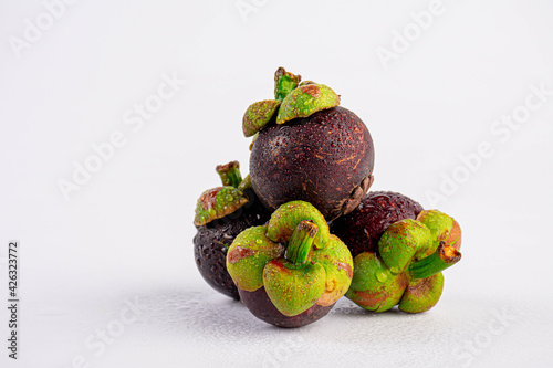 Mangosteen with water drops on white background 