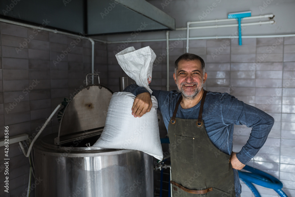 man working in mini craft brewery