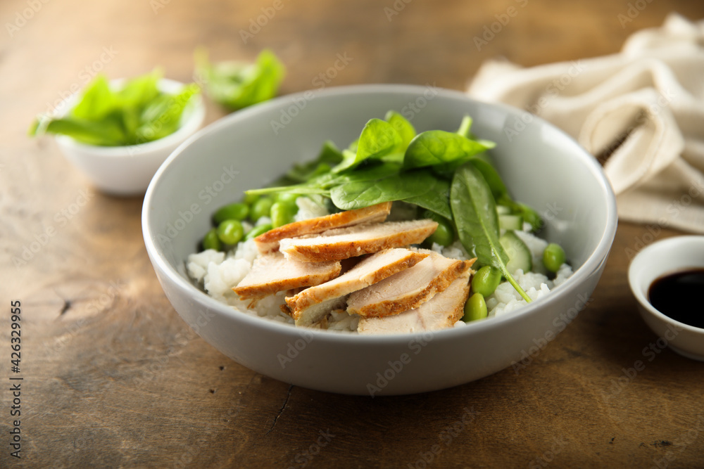 Healthy rice bowl with chicken and spinach