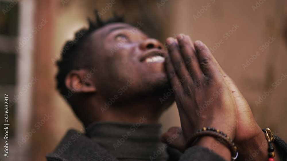 Spiritual black African praying looking up at sky seeking God Spiritual black African praying looking up at sky seeking God
