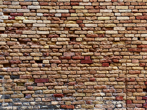 Horizontal part of a Venetian old red brick wall  background 