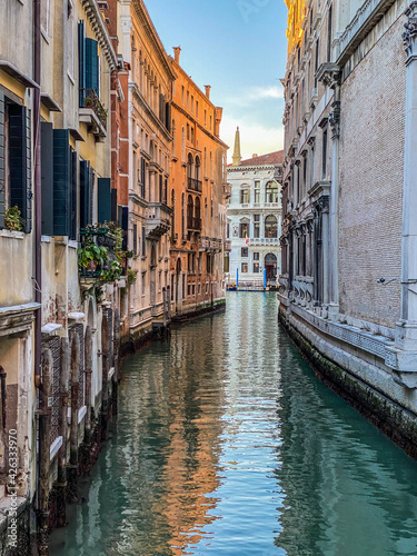 Small canal in Venice, Italy, with balcony, and, blue sky reflexion on water, no boat, no people © Eric Isselée