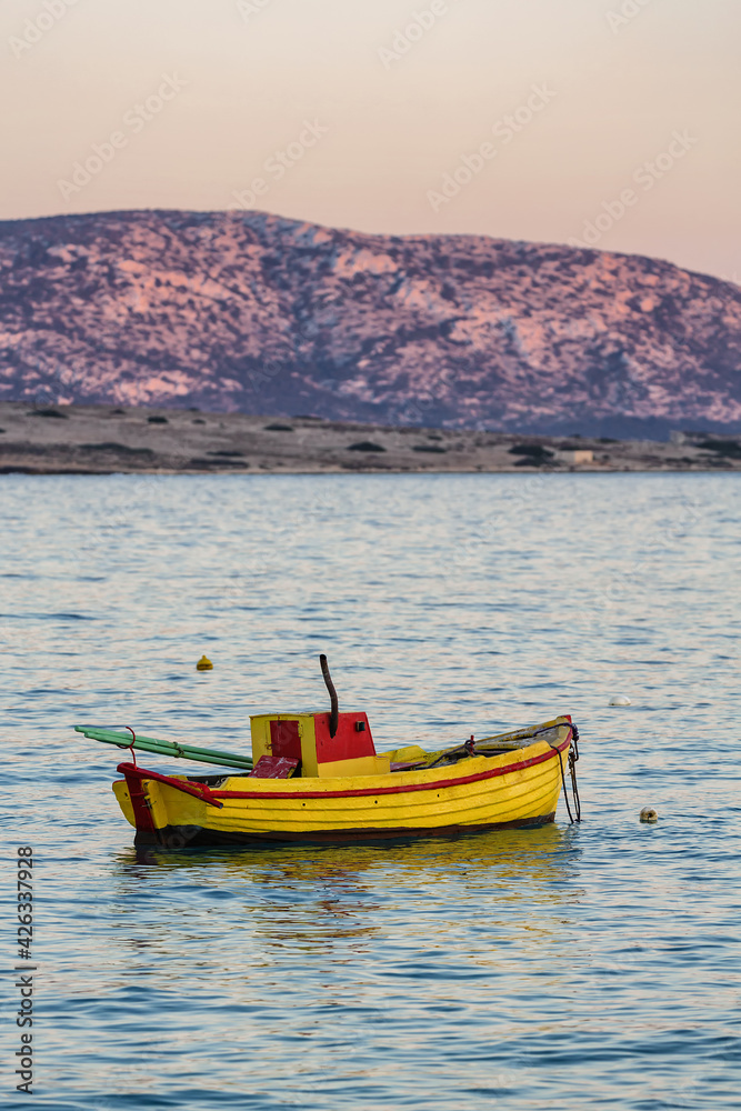 Yellow boat after sunset
