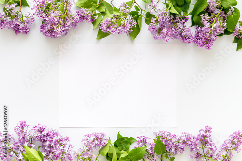 Frame of purple flowers - spring lilac branches with space for text