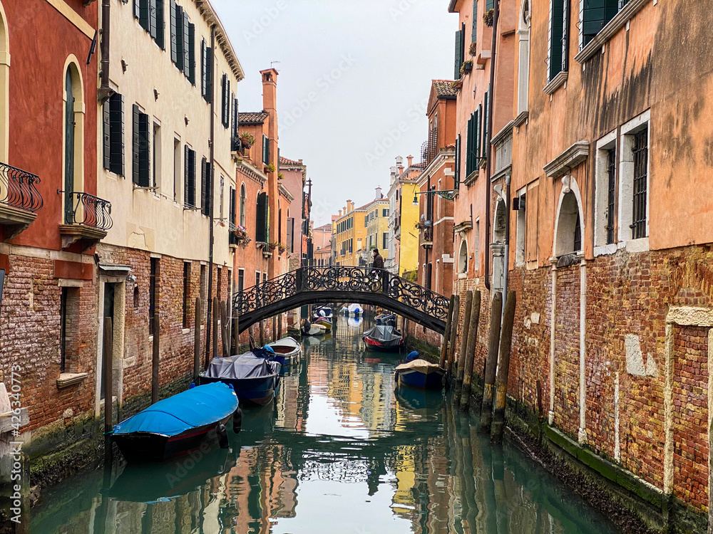 Unrecognizable person walking on a bridge in Venice, Italy
