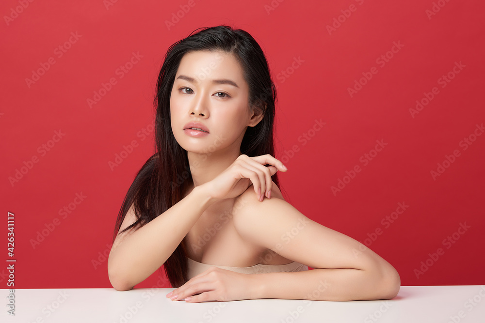 Beautiful young asian woman with clean fresh skin on red background, Face care, Facial treatment, Cosmetology, beauty and spa, Asian women portrait