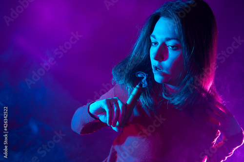 A young girl with a vape de...