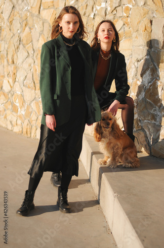 Two girls and english cocker spaniel dog.Portrait of dog outside (outdoors). Sunny day.