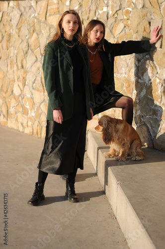 Two girls and english cocker spaniel dog.Portrait of dog outside (outdoors). Sunny day.