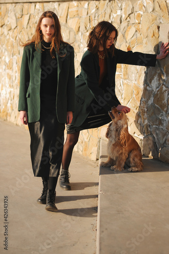 Two girls and english cocker spaniel dog.Portrait of dog outside (outdoors). Sunny day.
