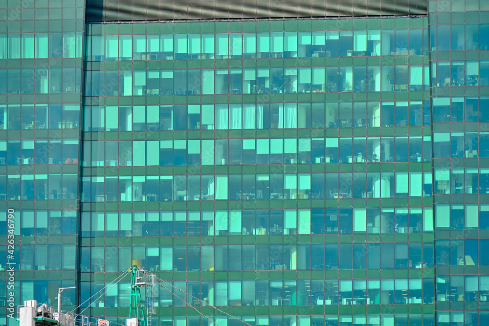 Green windows of a modern business center. Close view. Business background. Green windows of a modern business center. Close view. Business background.