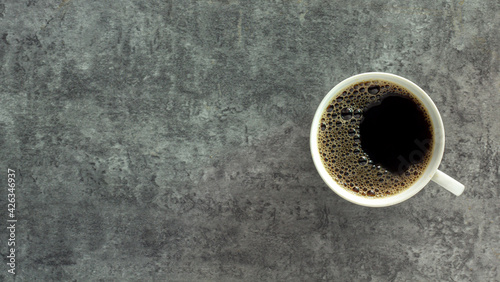 Pictured above, a bubble coffee drink in a white cup, a flavor of espresso, cappuccino, old and vintage background, is a hot morning drink to drink before breakfast with copy space for text.