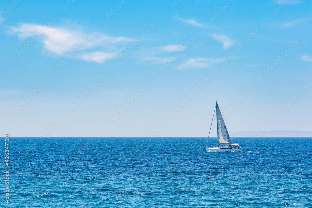 one sailboat at sea on a sunny day