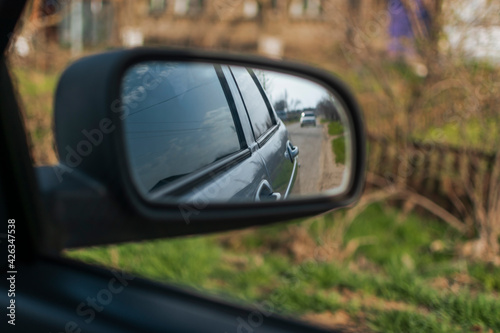 reflection in the side mirror of the car