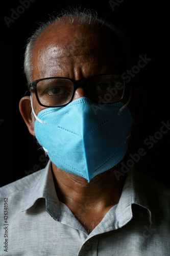 Portrait of 60 years old Indian man wearing mask (ID: 426348962)