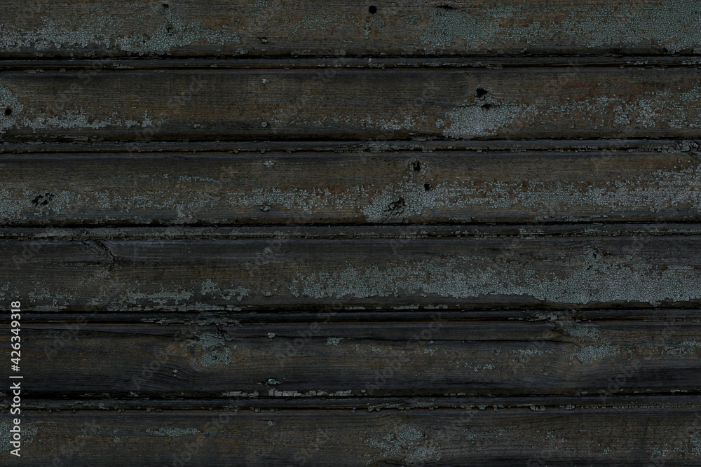 aged dark grey plank wall with cracked green paint