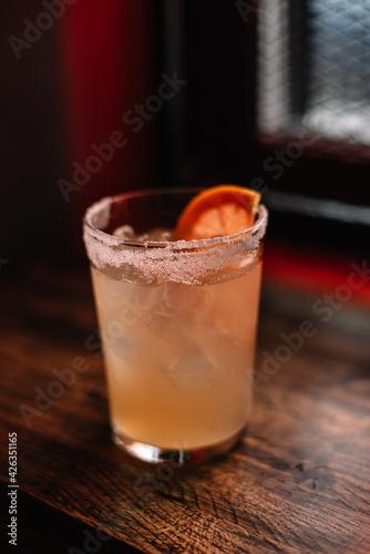 Cuban Pornstar cocktail decorated with slice of grapefruit as a garnish.