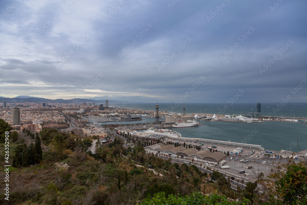 View of the city of Barcelona before the storm. Dramatic sky, on the horizon the sea with waves.