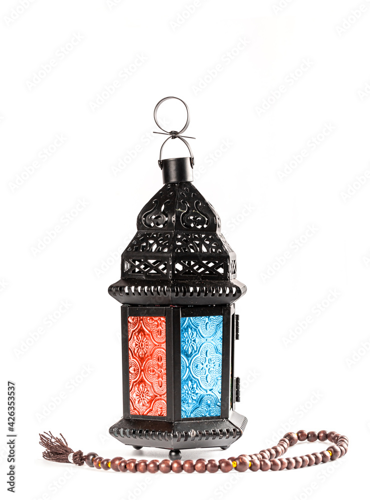 Muslim holiday of the holy month of Ramadan Kareem. Beautiful background with prayer beads and arabic luminous lantern on white