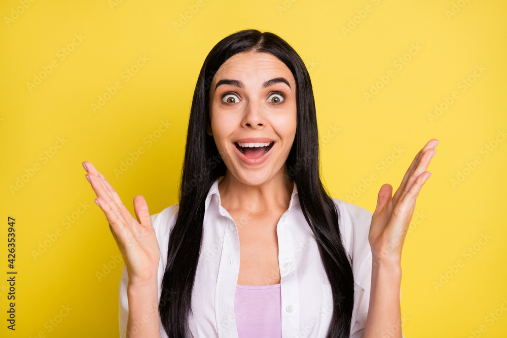 Photo of amazed cheerful lady raise hands happy discount present good mood isolated on yellow color background Photo of amazed cheerful lady raise hands happy discount present good mood isolated on yellow color background