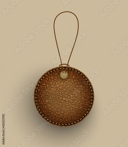 Brown leather round badge hanging on string