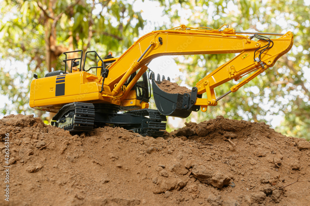 Yellow Excavators are digging the soil in the construction site location outdoor