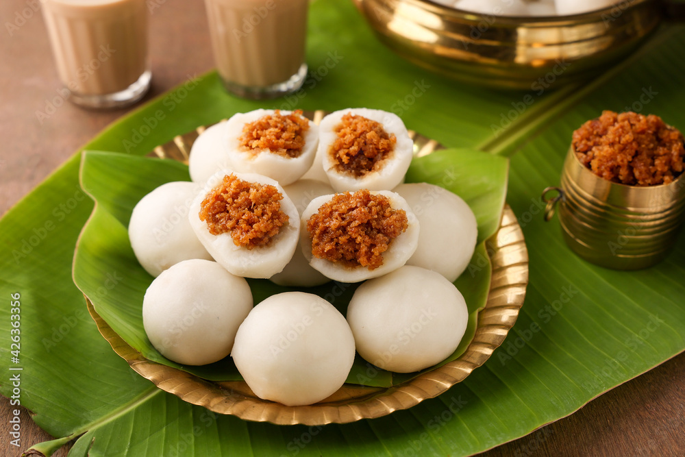 Kozhukatta Pidi in golden plate Indian milk tea Kerala tea time snack steamed food sweet modak rice dumpling Ganesh Festival India sweet food stuffed grated coconut jaggery christian food Palm sunday Kozhukatta Pidi in golden plate Indian milk tea Kerala tea time snack steamed food sweet modak rice dumpling Ganesh Festival India sweet food stuffed grated coconut jaggery christian food Palm sunday
