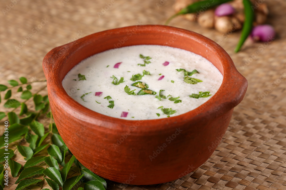 Spiced buttermilk , chaas , chaach , moru , sambharam , curd, lassi , yogurt, cool refreshing drink for hot summer in a clay pot, Kerala, India. Flavored Indian buttermilk. Spiced buttermilk , chaas , chaach , moru , sambharam , curd, lassi , yogurt, cool refreshing drink for hot summer in a clay pot, Kerala, India. Flavored Indian buttermilk.