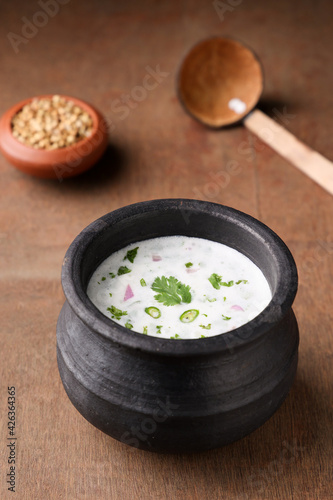 Spiced buttermilk , chaas , chaach , moru , sambharam , curd, lassi , yogurt, cool refreshing drink for hot summer in a clay pot, Kerala, India. Flavored Indian buttermilk. photo