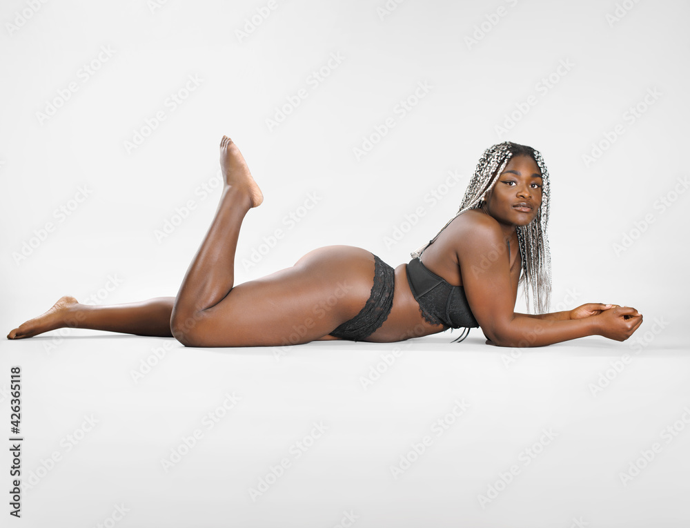 attractive authentic woman lying on isolated background