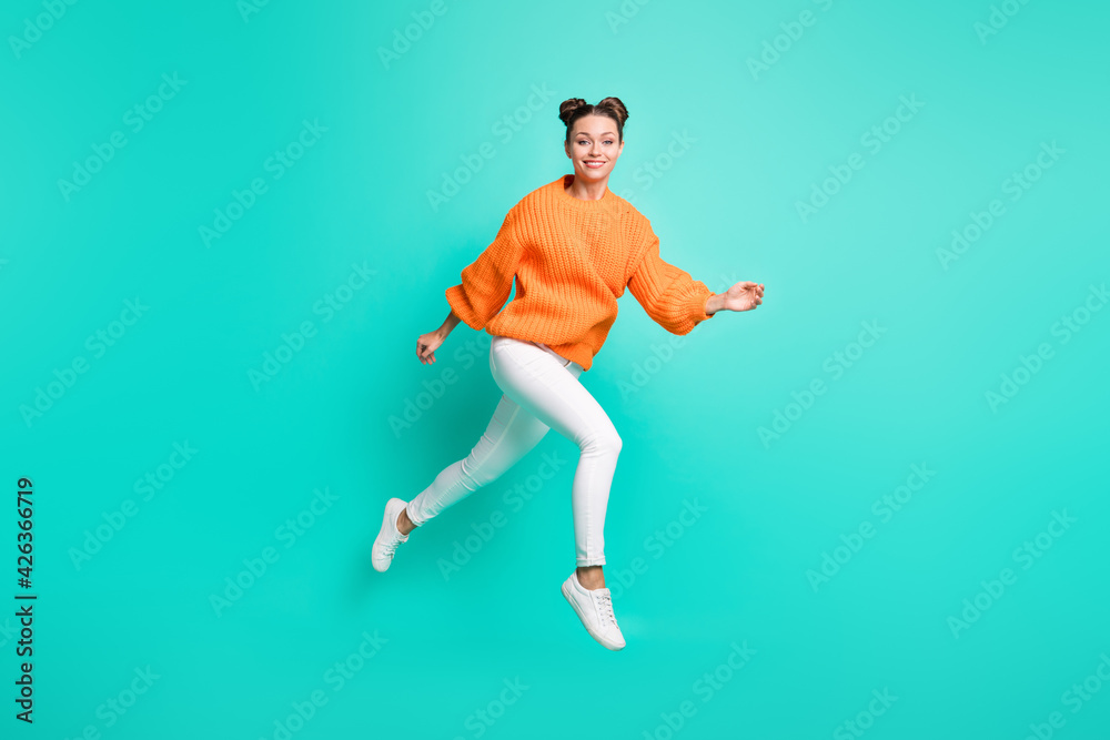 Full size photo of young lovely charming positive girl running in air wear knitted pullover isolated on teal color background