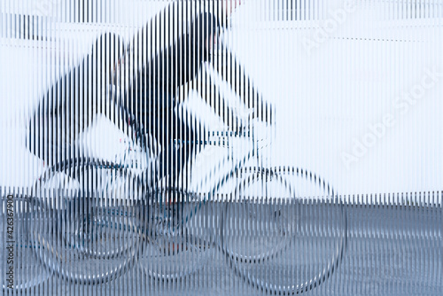 stripes image, movement of a cyclist with black jacket on white background photo