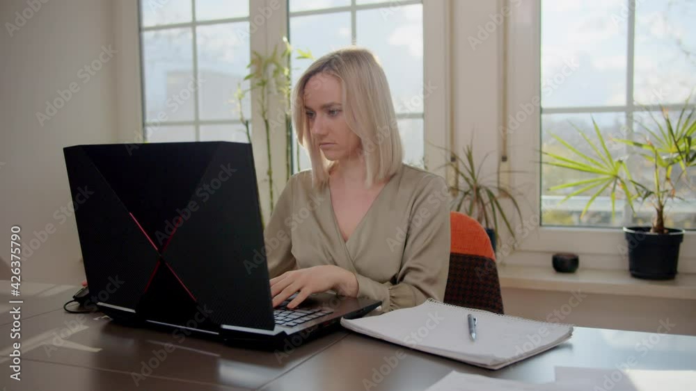 Millennial woman making video chat working from home using laptop. Young female online teacher conferencing on business call communicating by webcam on computer. Distance telework Millennial woman making video chat working from home using laptop. Young female online teacher conferencing on business call communicating by webcam on computer. Distance telework