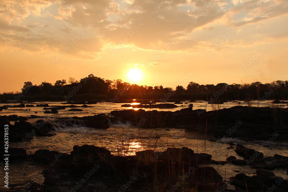 Obraz premium beautiful sunset at the okavango river in namibia