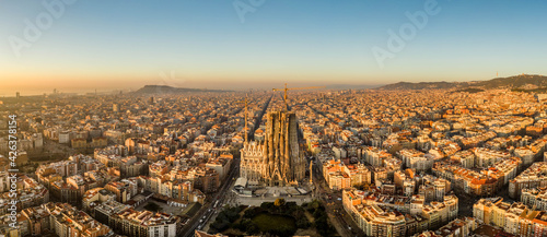 Aerial panorama drone shot of Barcelona city center in sunrise golden hour in Spain winter