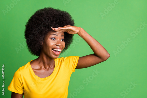 Photo of young happy excited crazy afo woman looking forward ahead in copyspace isolated on green color background
