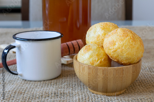 wooden bowl with cheese bread and white coffee mug